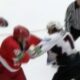 A big hockey fight ensues after a minor foul in a match between two rival hockey teams
