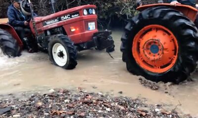 Another tractor carefully saved the tractor that crashed in the stream.