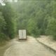 Trucks carrying cargo from country to country travel in difficult conditions during their long journeys, a road in the Balkans is extremely flooded