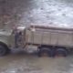 Trucks hauling timber from mountainous forest areas are crossing rivers without