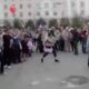 A former communist woman celebrates Victory Day in the town square by stripping